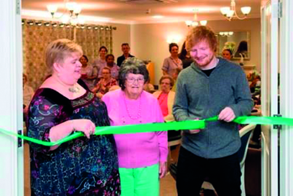 Ed Sheeran cutting ribbon low res