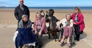 Residents and Staff at Colwyn Bay Home Make Short Journey to Beach to See Terry Jones Statue